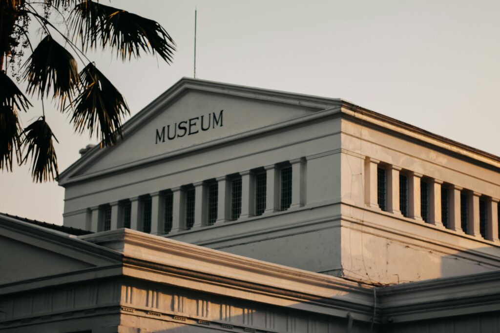 Low angle view of a historic museum building in urban setting at sunset.